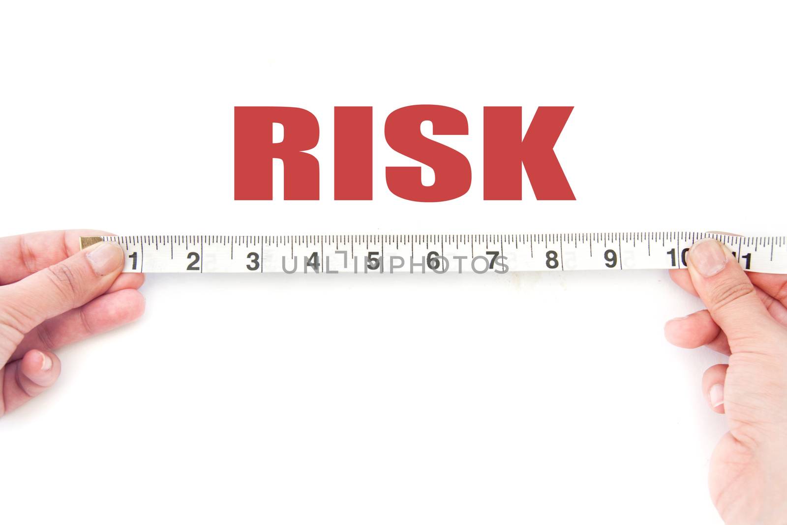 Tape measuring risk over a white background