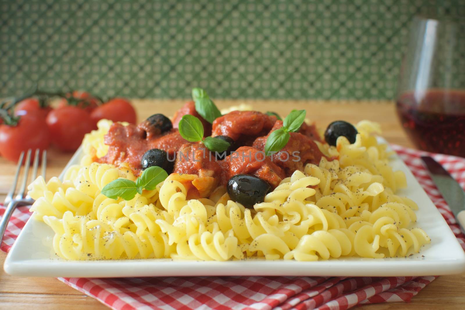 Italian pasta dish with tomato sauce and basil 