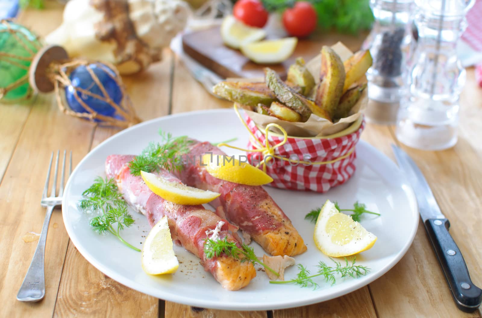 Bacon wrapped salmon fillets with potato wedges