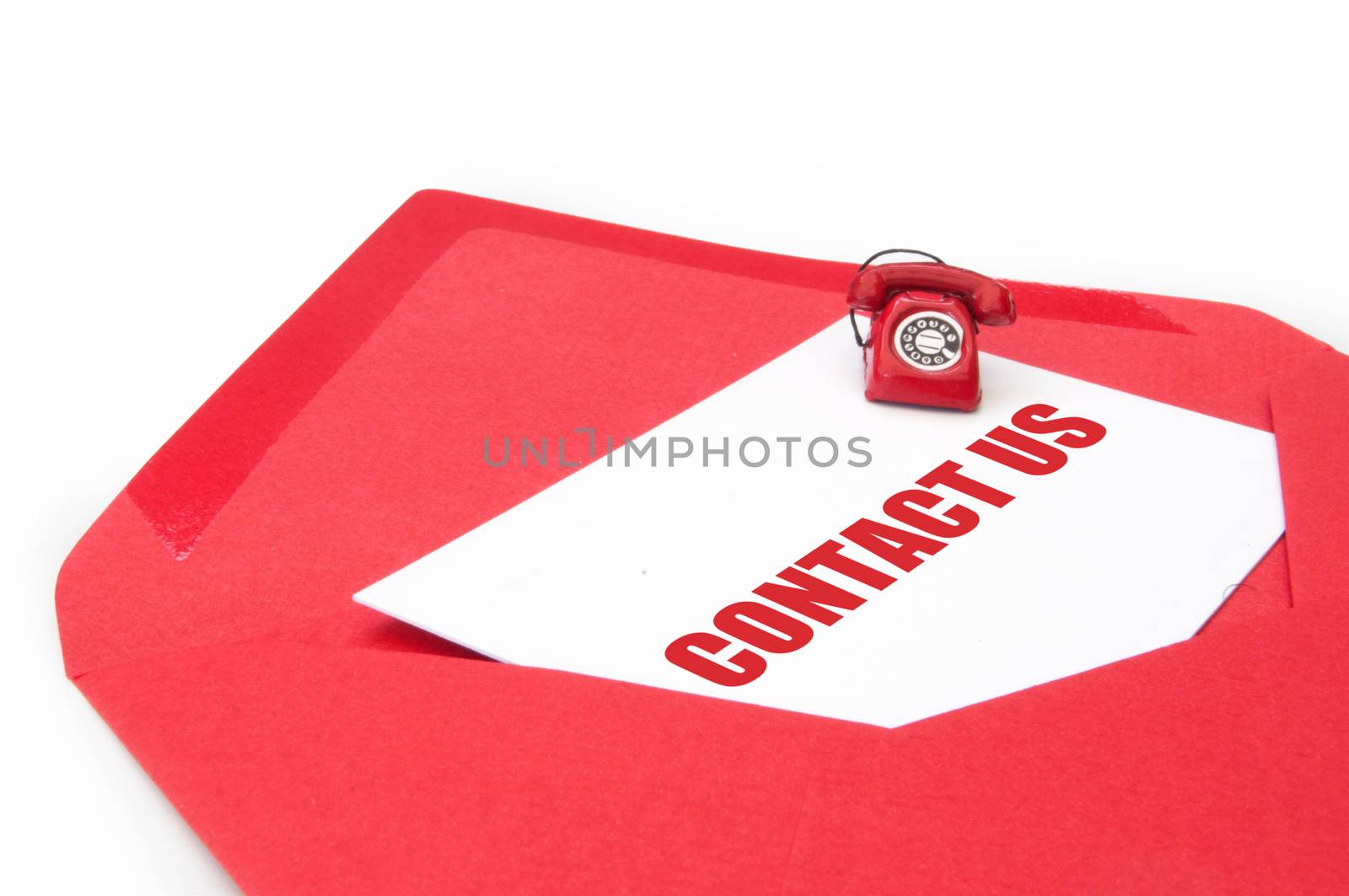 Contact us business card inside an open envelope with a small phone on one side 