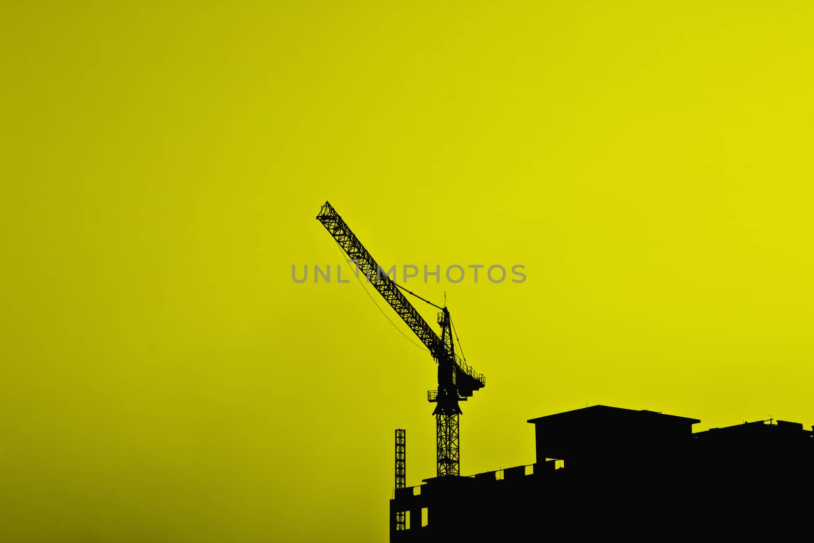 Industrial construction cranes and building silhouettes