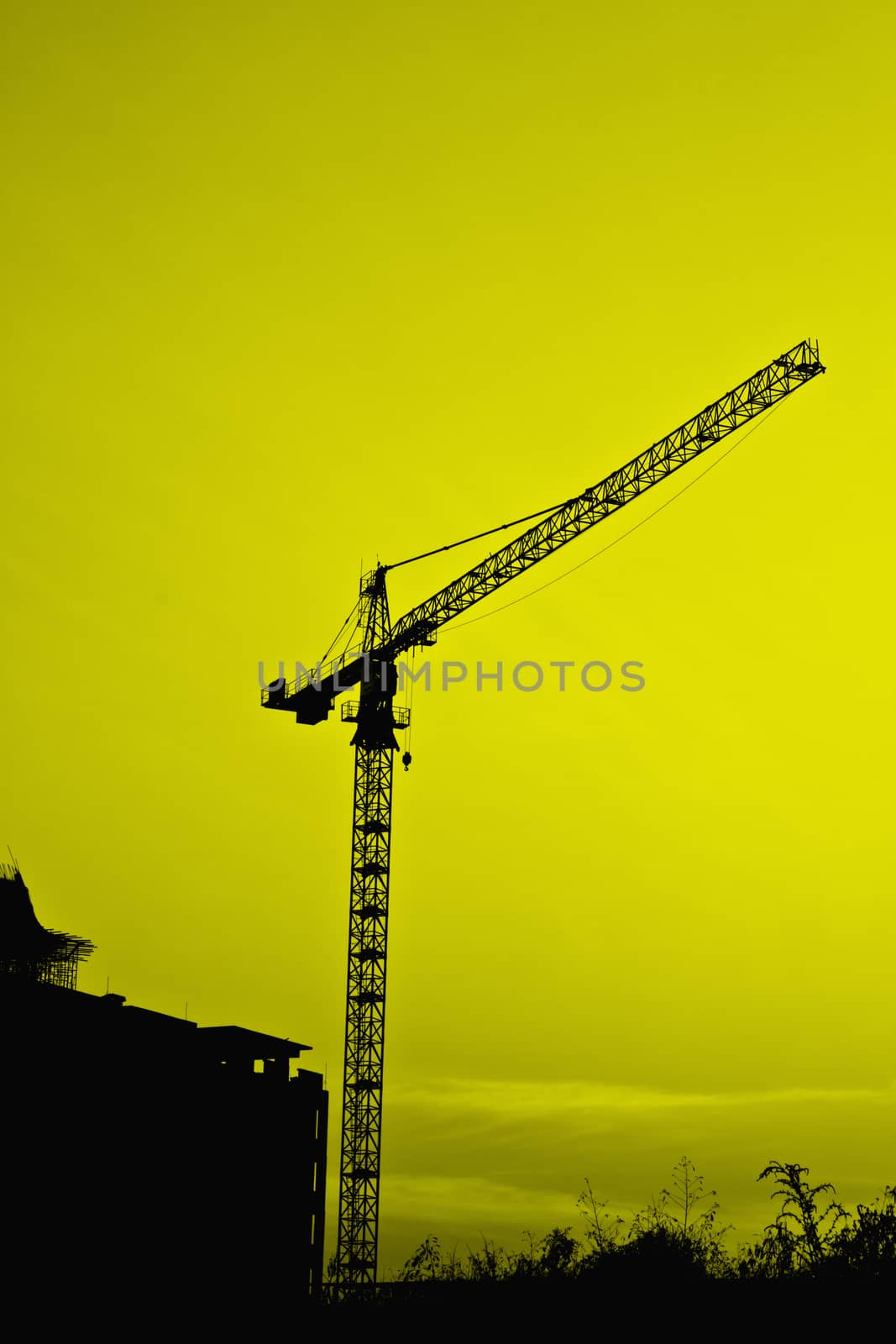 Industrial construction cranes and building silhouettes