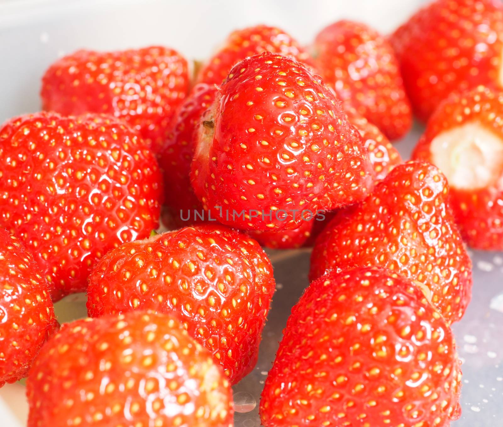 Pile of whole fresh red  strawberries without green grass