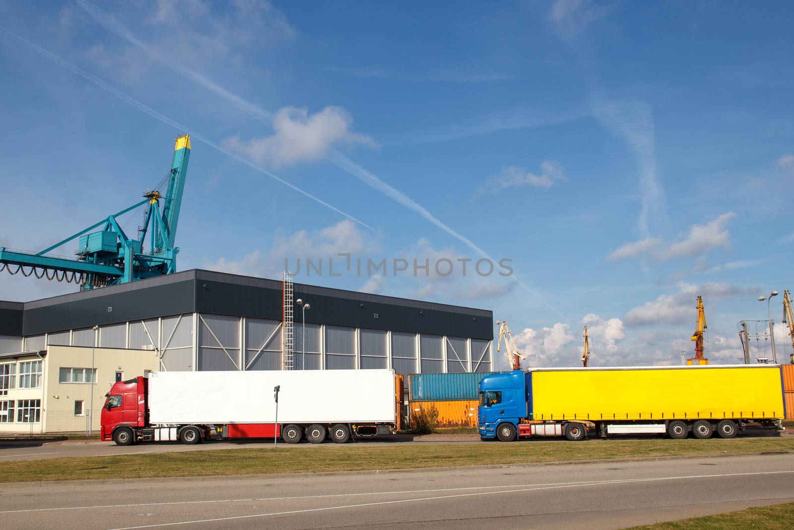 A couple of export trucks parked in front of a factory