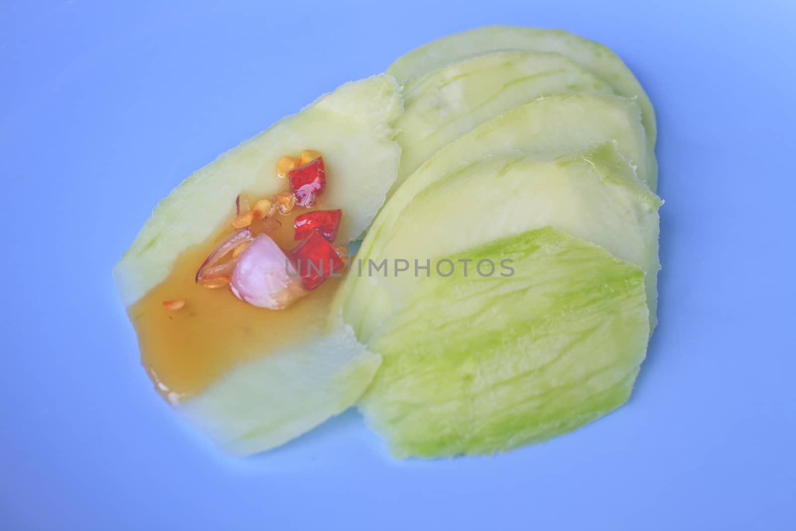 mangoes with sauce, mangoes dipped into a sweet fishy paste with dried shrimp and red onions in plate