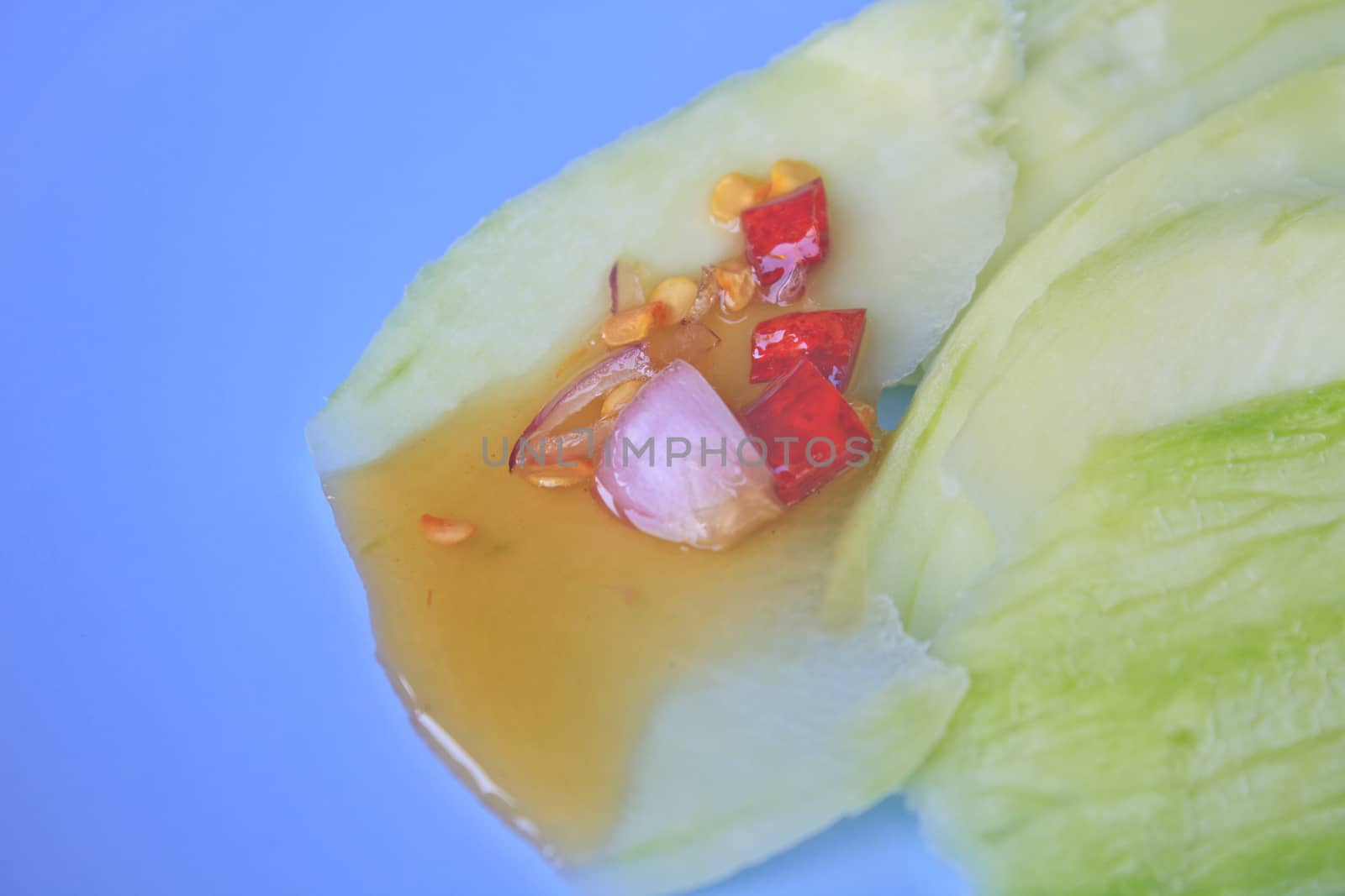 mangoes with sauce, mangoes dipped into a sweet fishy paste with dried shrimp and red onions in plate