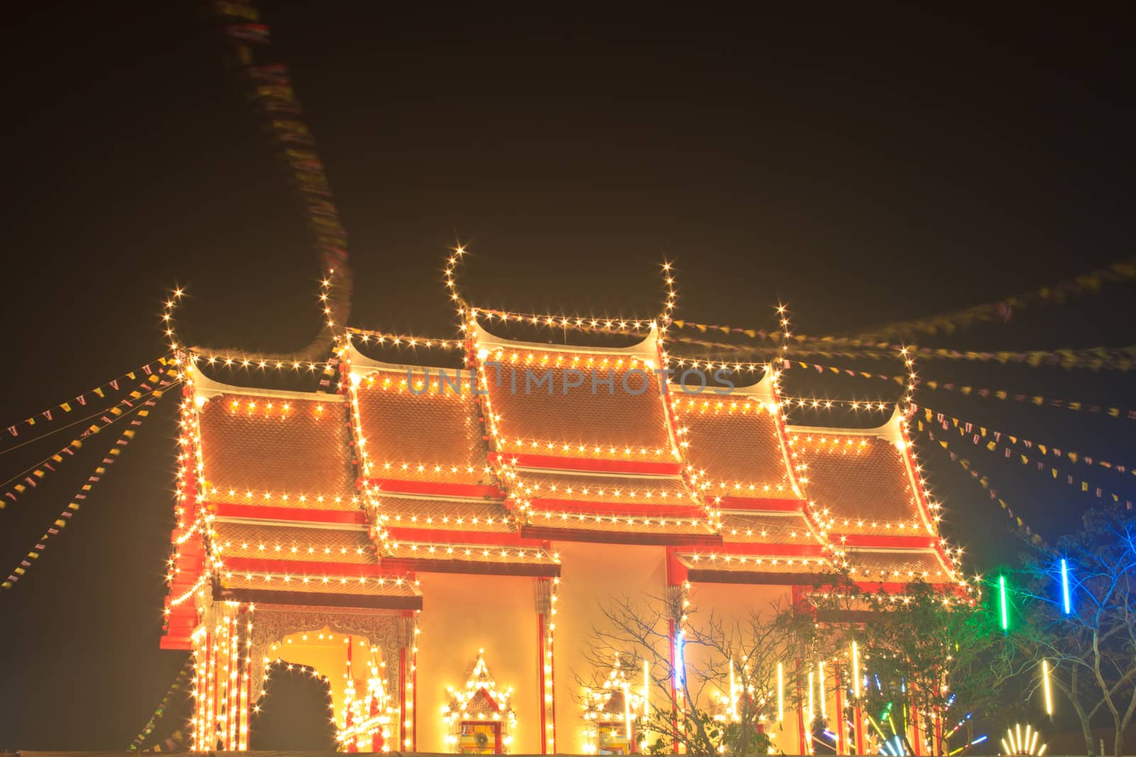 Pagodas and churches at the night in the temple fair,Thailand