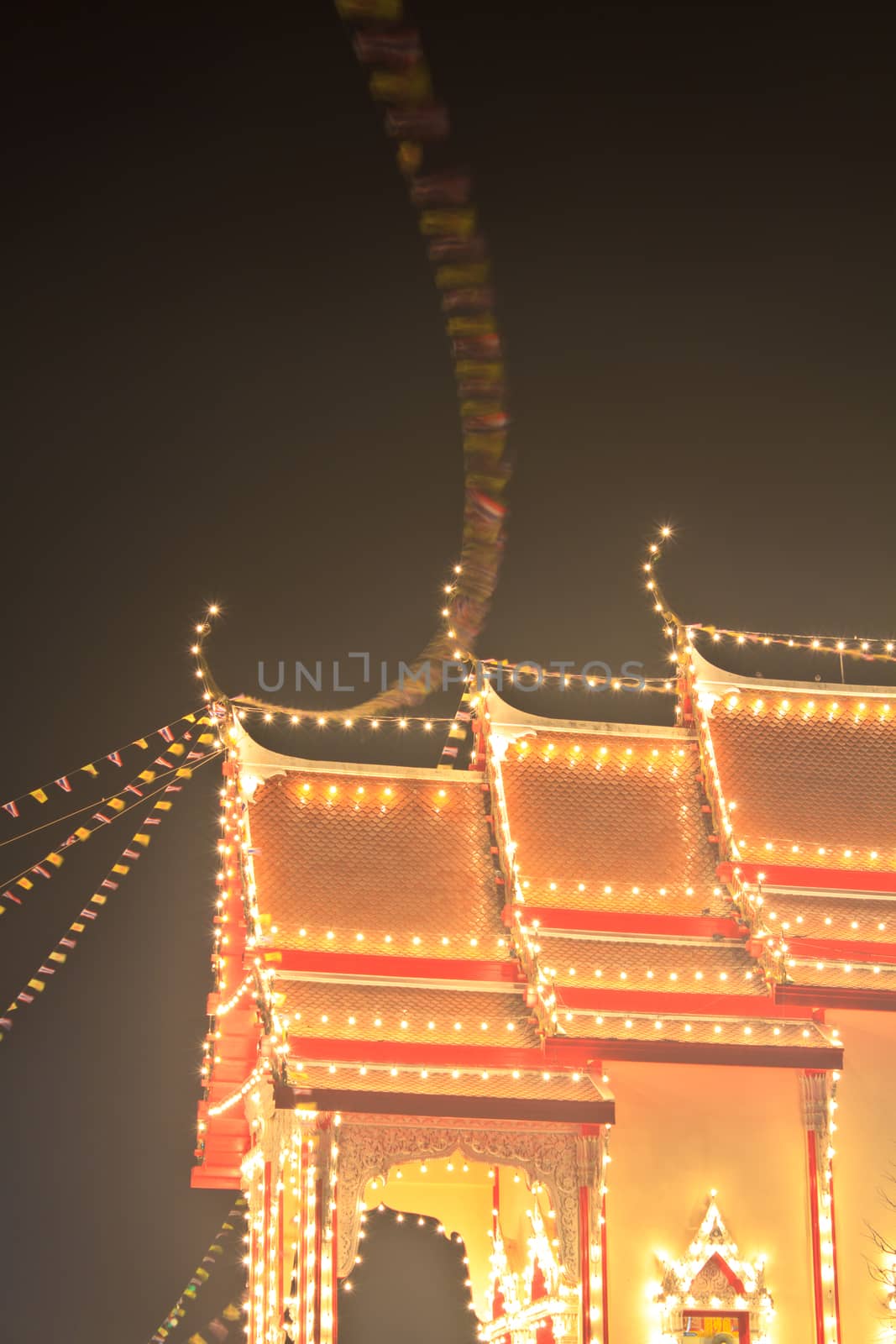 Pagodas and churches at the night in the temple fair,Thailand