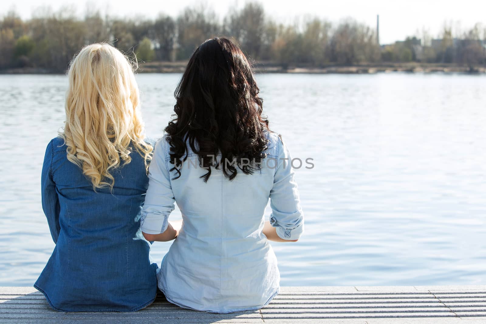 Friendship. Best friends sitting by the river