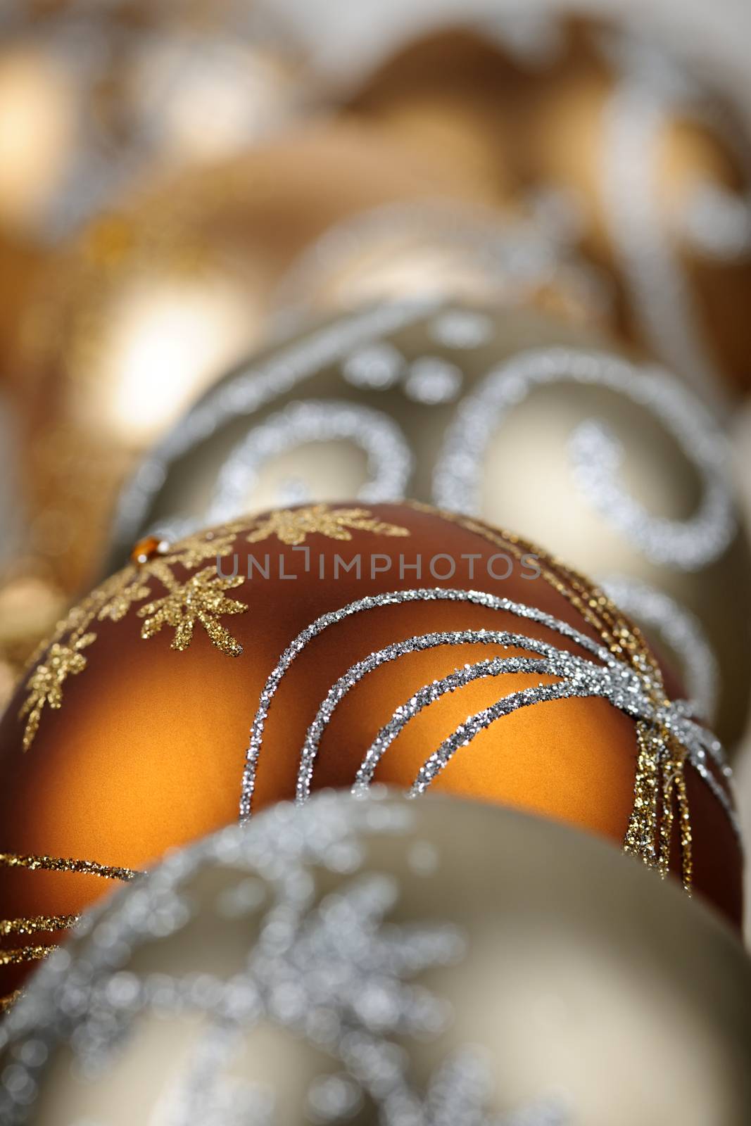 Closeup of golden Christmas balls with festive designs