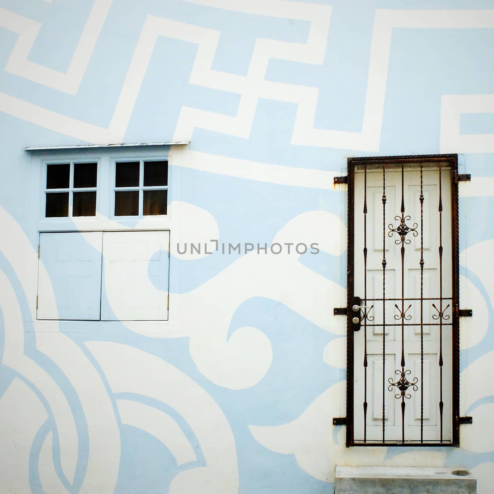 Exterior of painted building with door and window by nuchylee