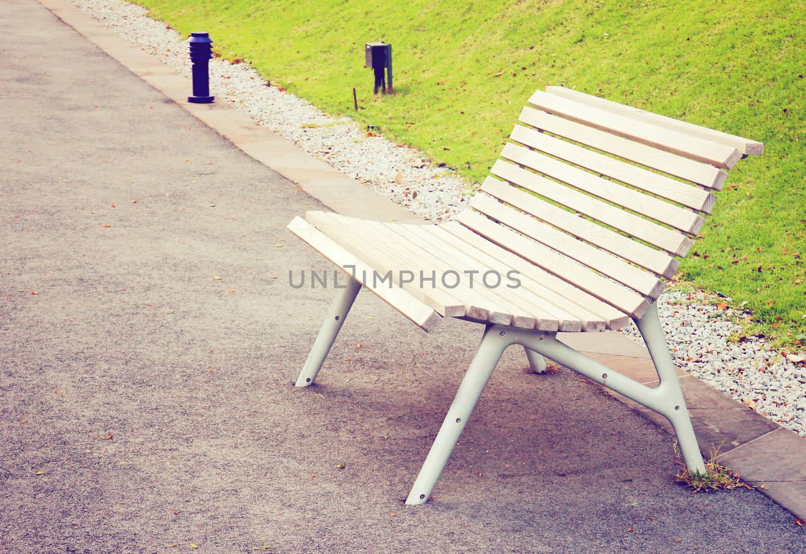 Empty wooden bench in the park with retro filter effect