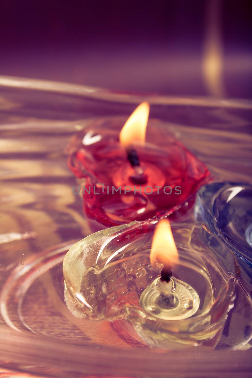 floating burning candles in glass aroma bowl - retro effect