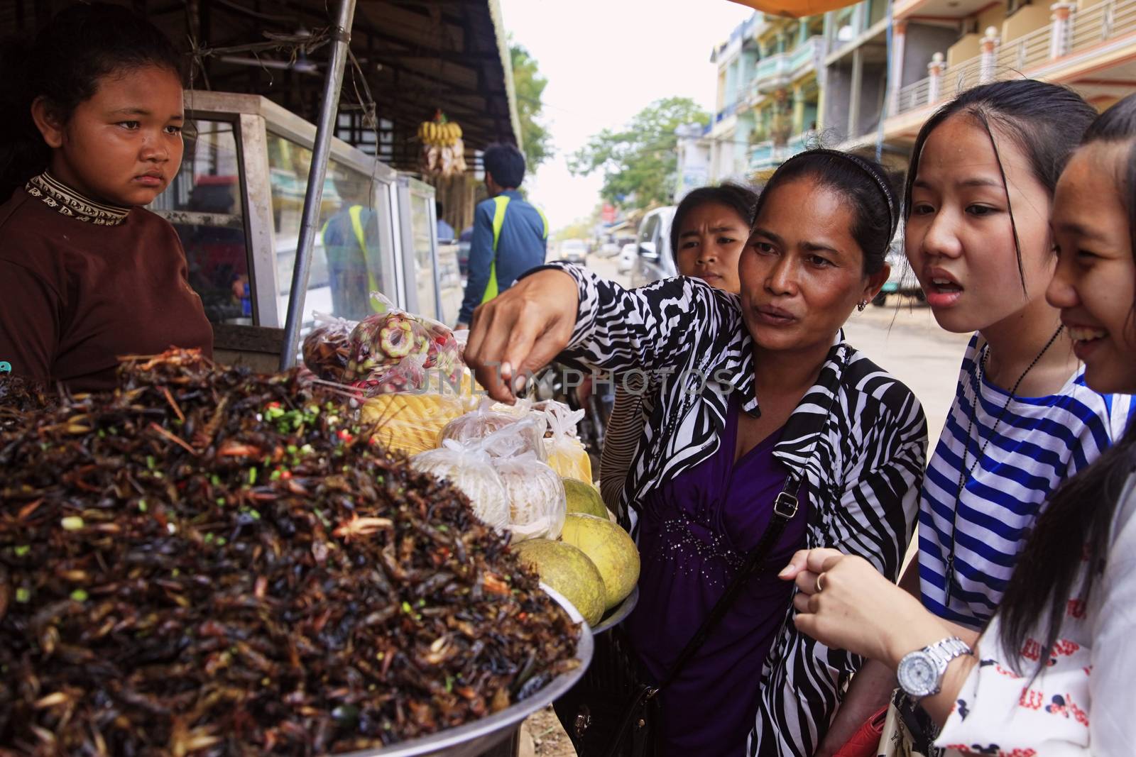 SIEM REAP, CAMBODIA - APRIL 10, 2014 : unknown Cambodian women selling fried insects at market in Seam Peap, 10 April 2014, Cambodia. Insects is traditional asian delicacy and In future, it can be a major source of protein