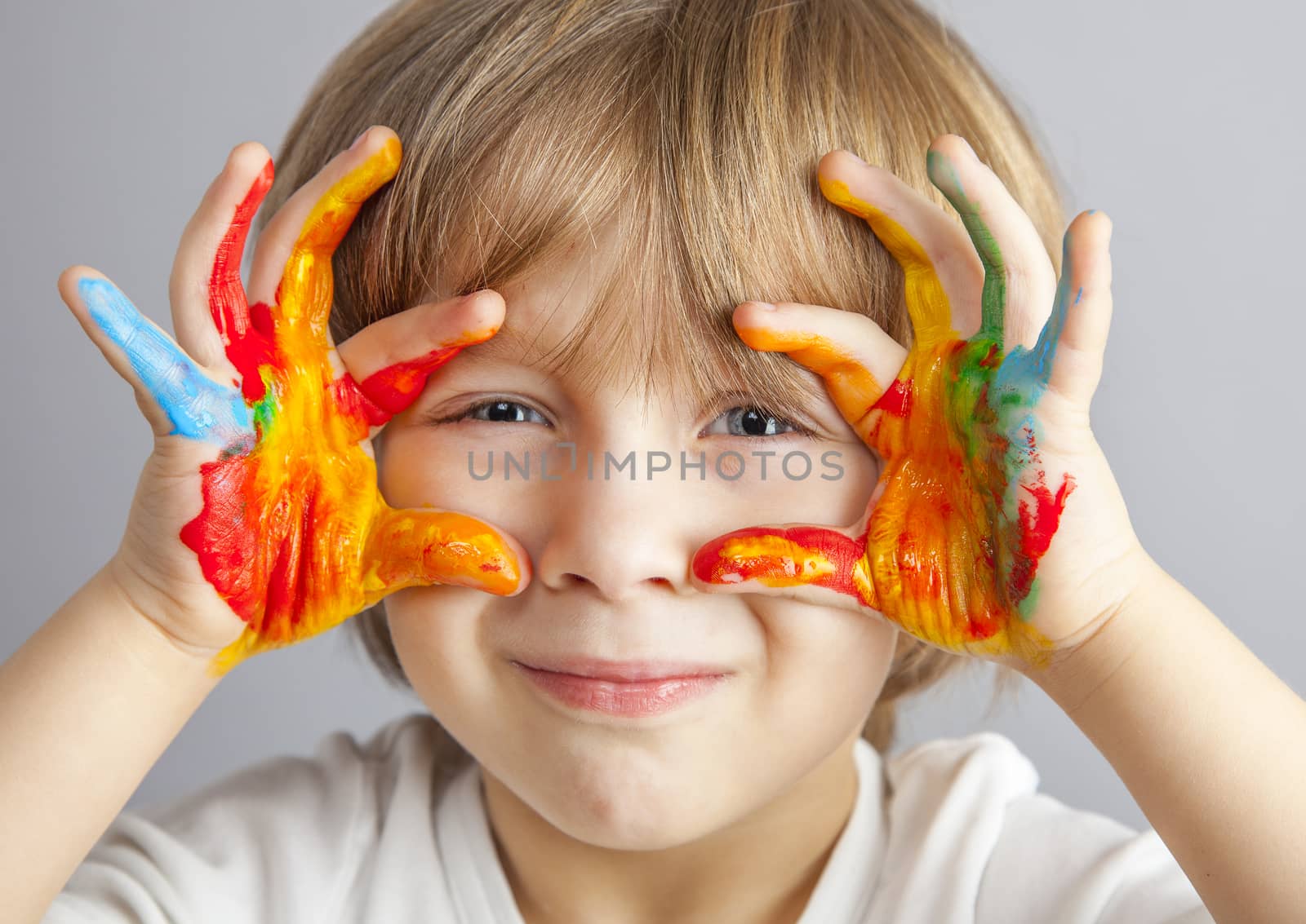 little girl and boy hands painted  in colorful paints