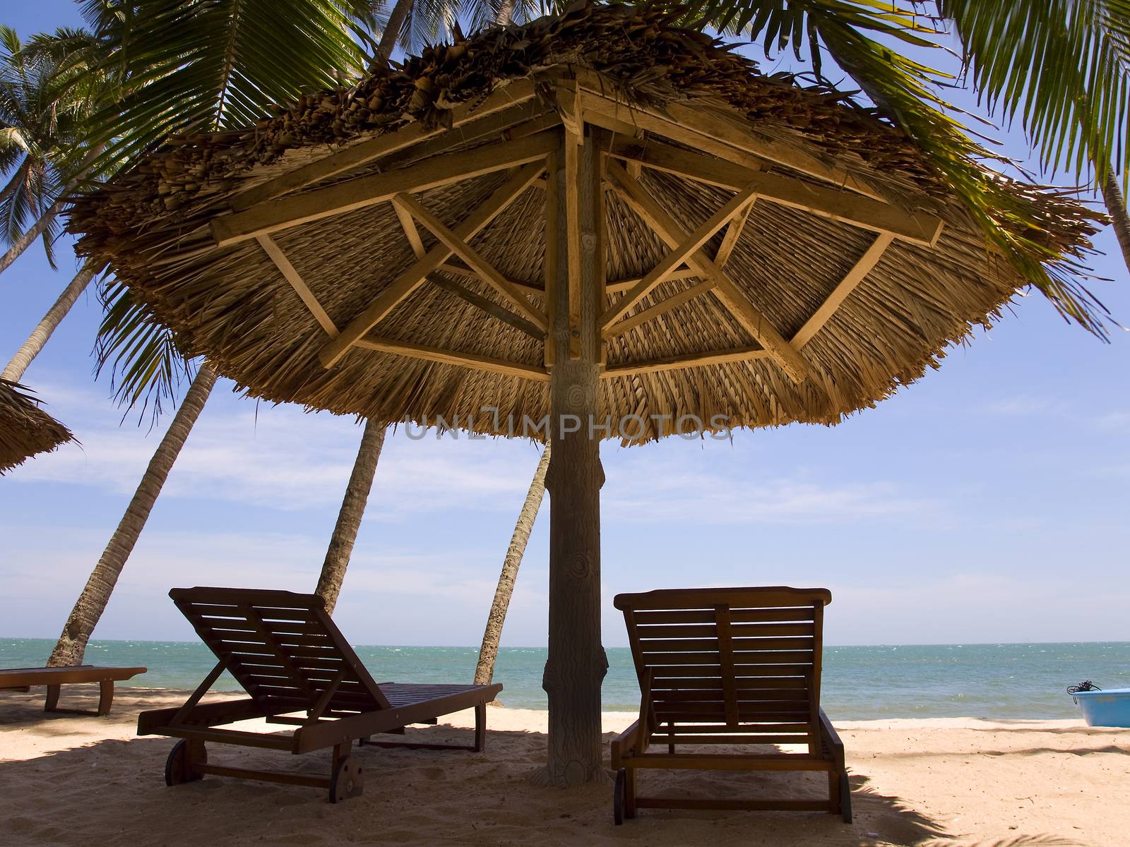 sun loungeres and  Umbrellas against  blue sea at sun day Mui Ne, Vietnam