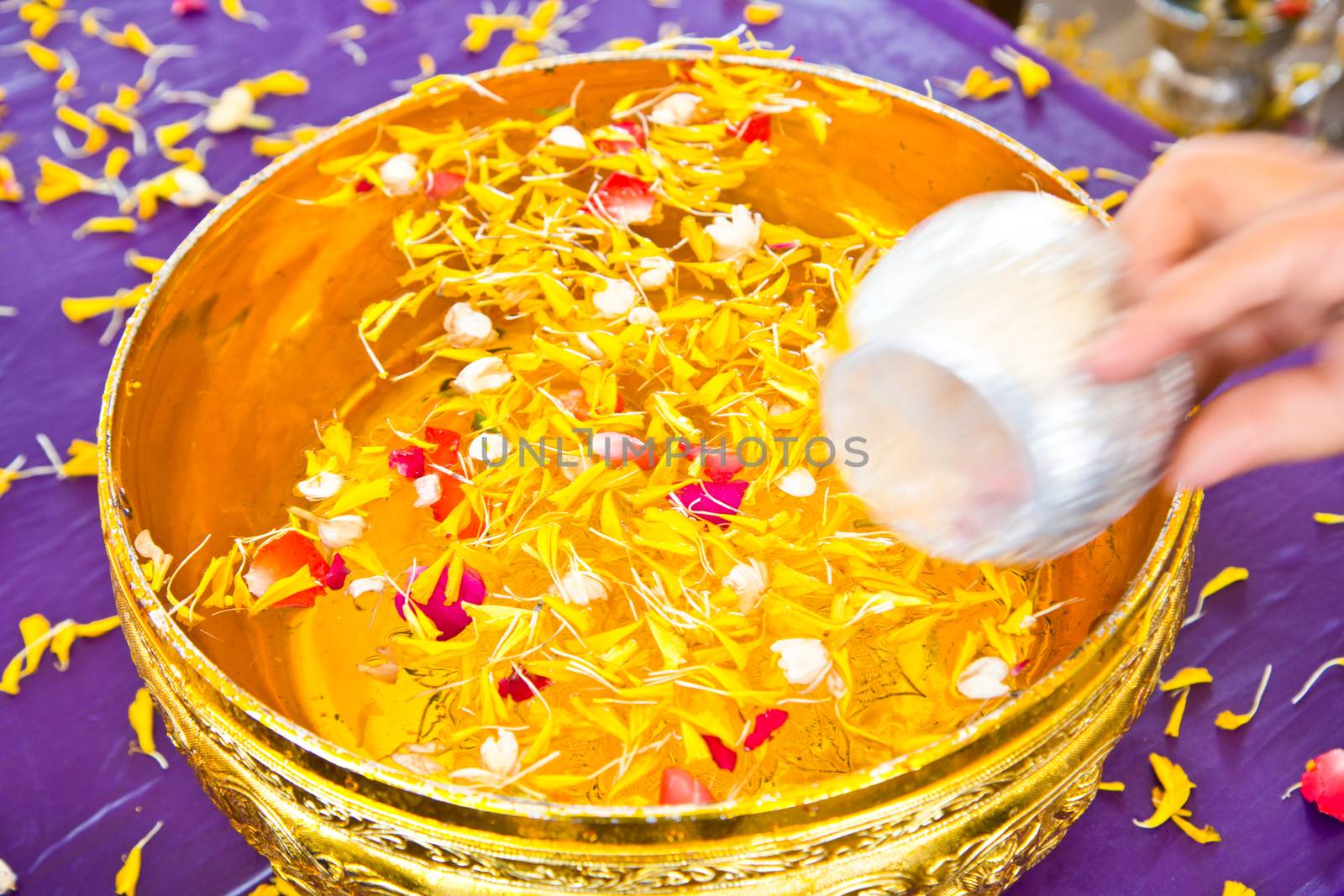 Water in bowl mixed with perfume and  flowers for Songkran festi by tisskananat