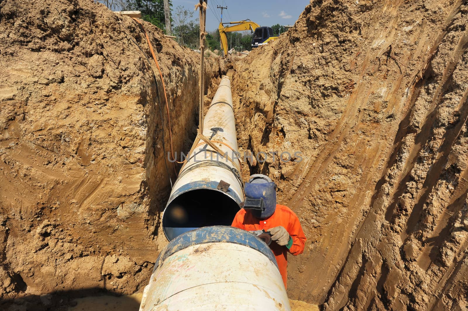 water pipes and worker on duty by think4photop