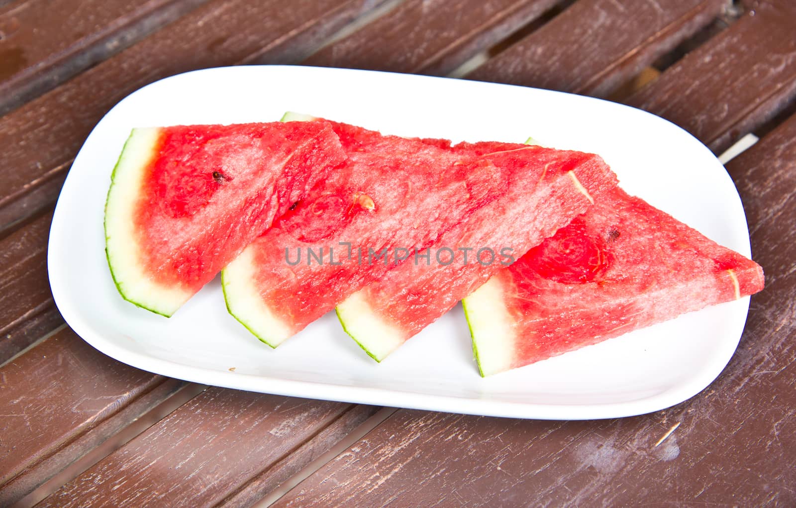 Close-up of fresh slices of red watermelon by tisskananat