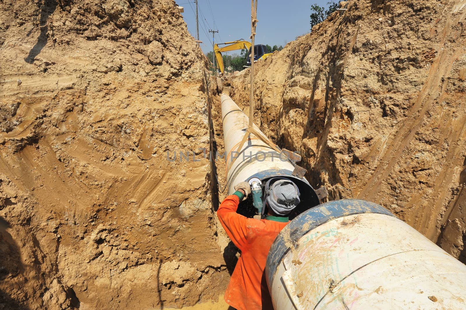 water pipes and worker on duty by think4photop