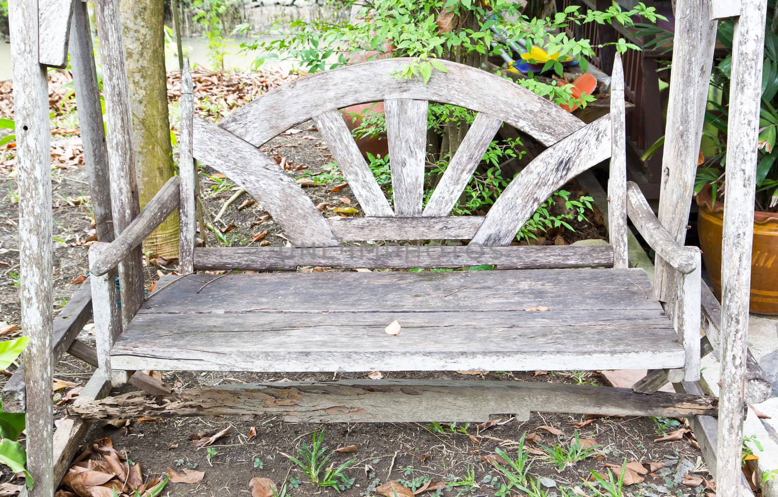 Vintage wooden swing in the garden by tisskananat