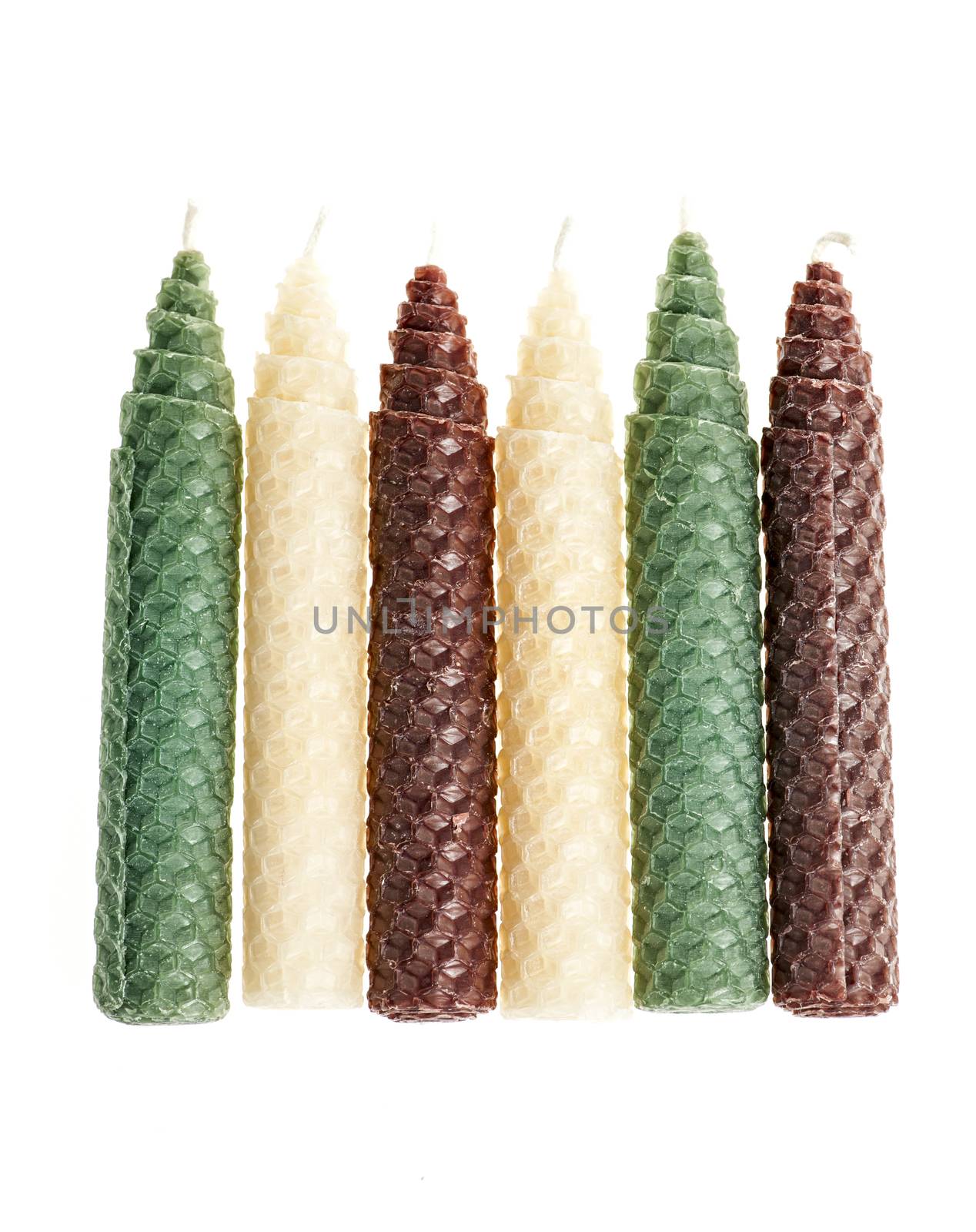 Colorful beeswax candles isolated on white background