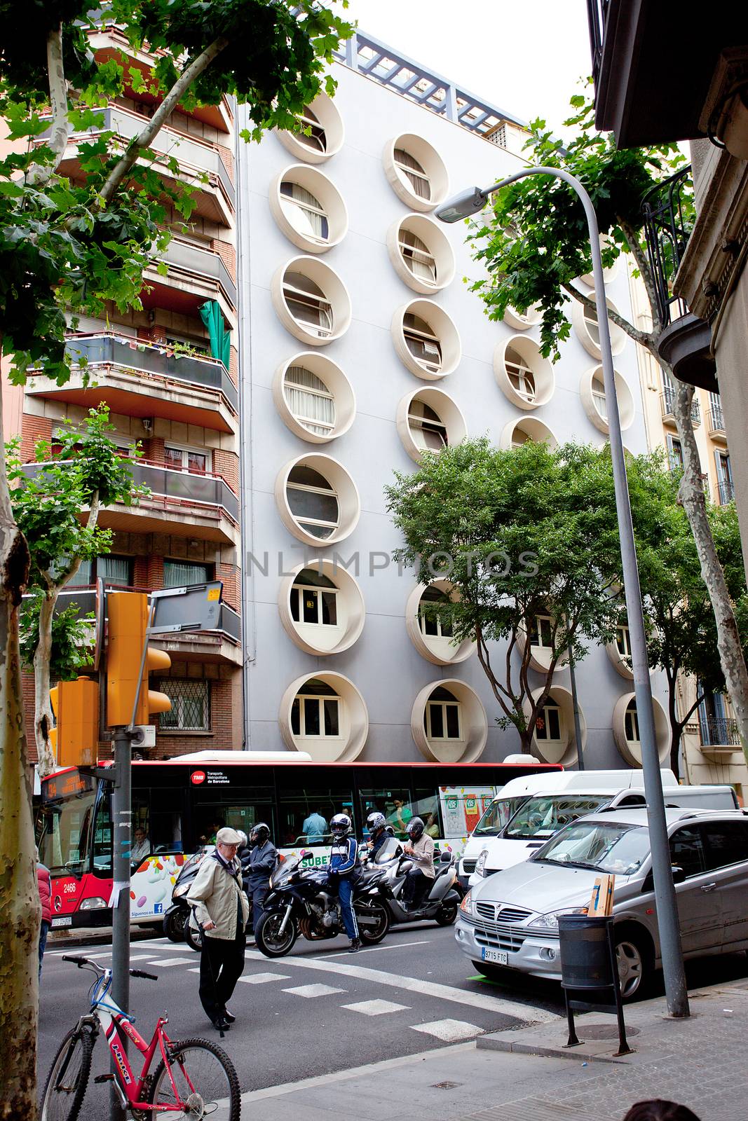 architecture in the streets of Barcelona, 13 June 2013: pedestrian crossing near the apartment house with round windows, Editorial use only