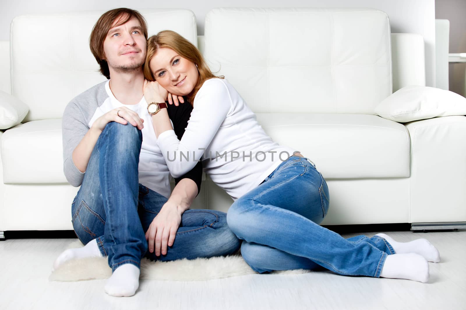 Happy couple relaxing in living room