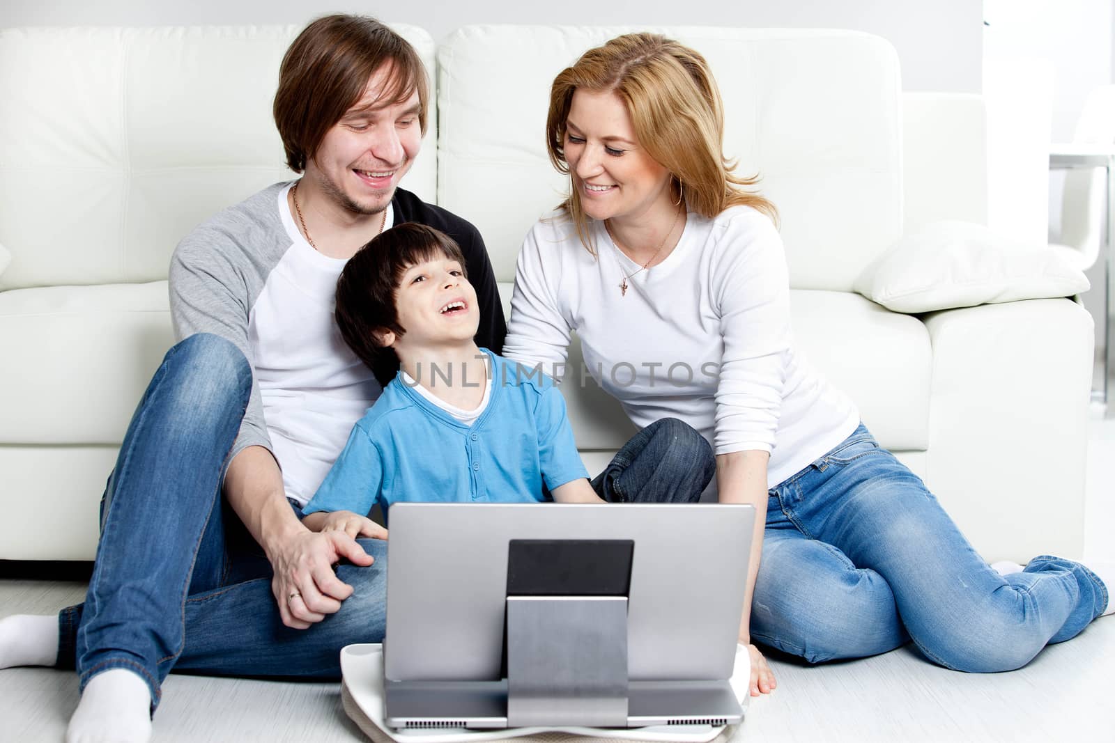 Young parents with children with laptop computer