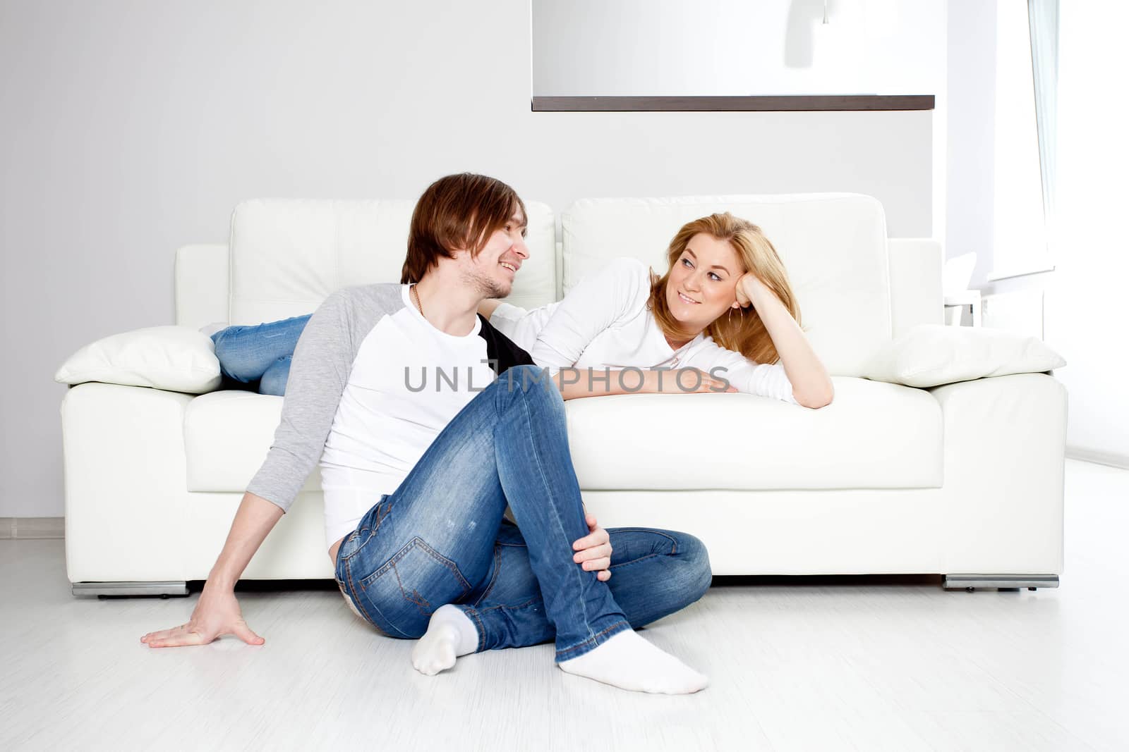 Couple Relaxing On Sofa  In New Home