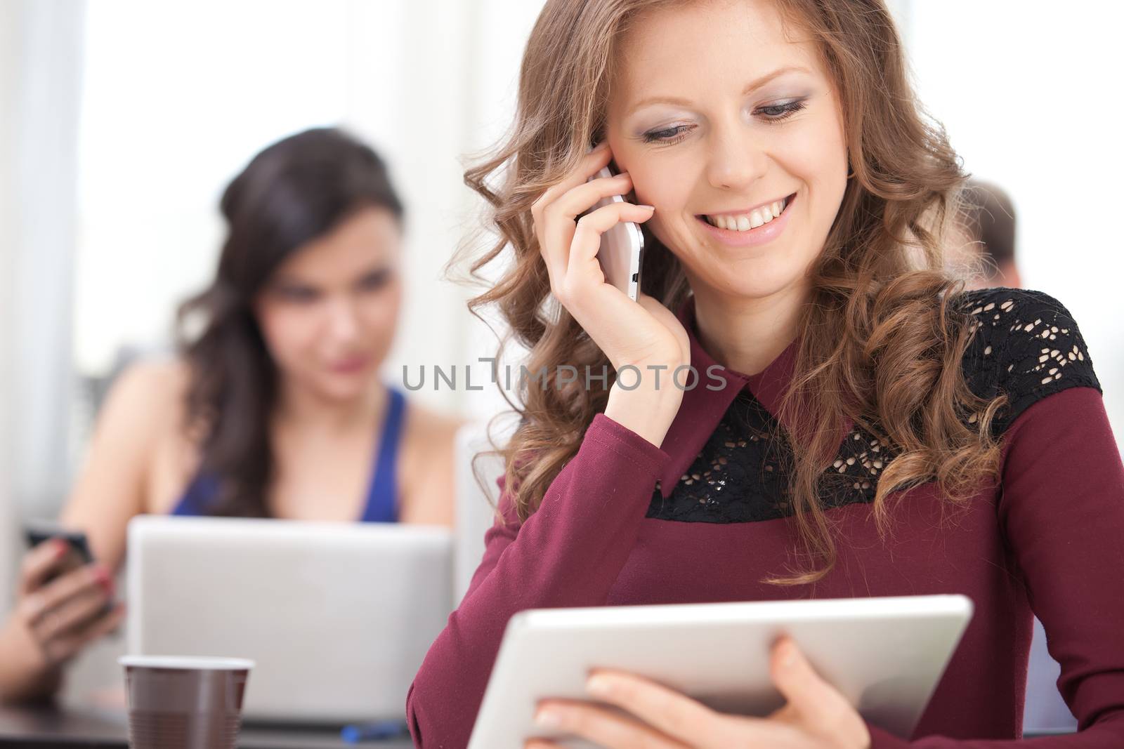 smiling young girl talking on the phone at class