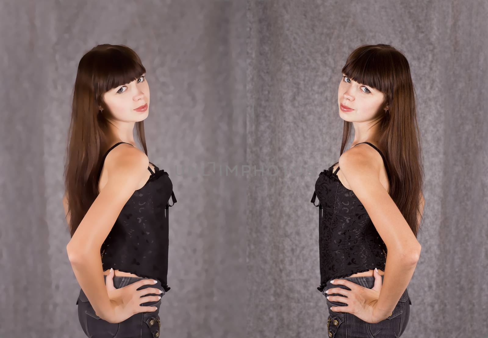 Portrait of a girl with long dark hair, dressed in black clothes on gray blurred background