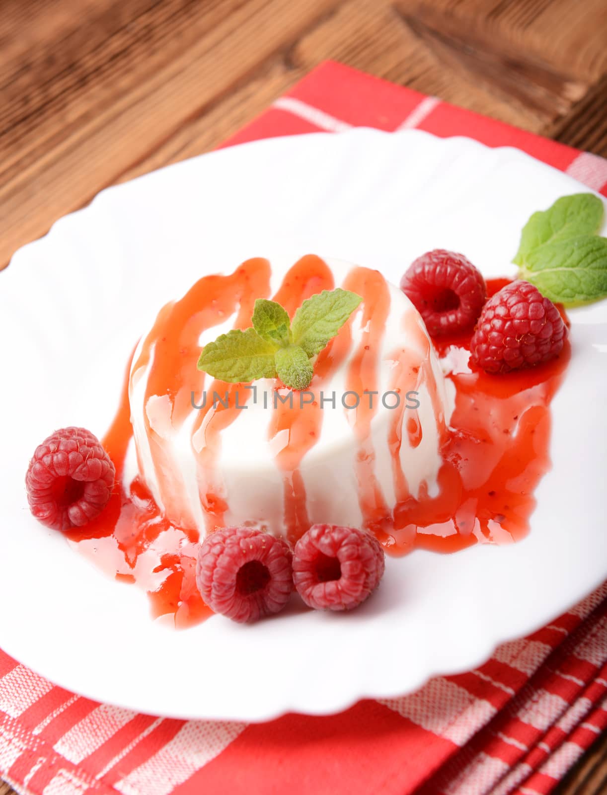 Italian dessert panna cotta with raspberries