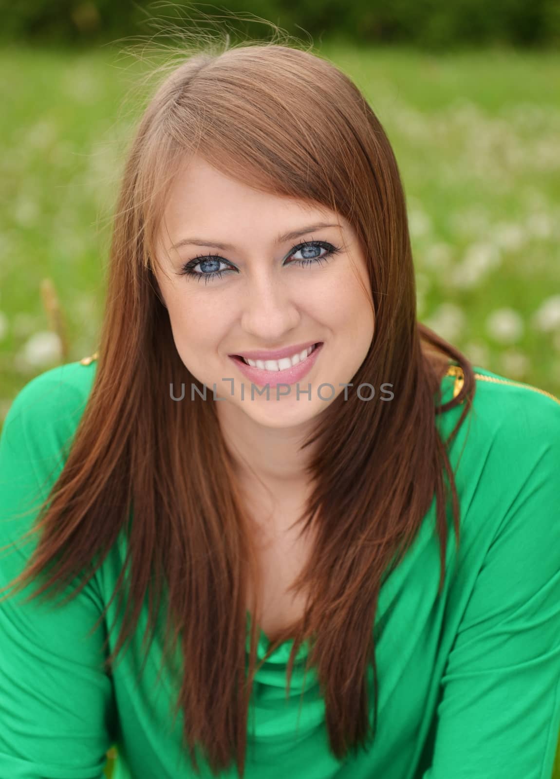 beautiful brunette posing against fresh green background