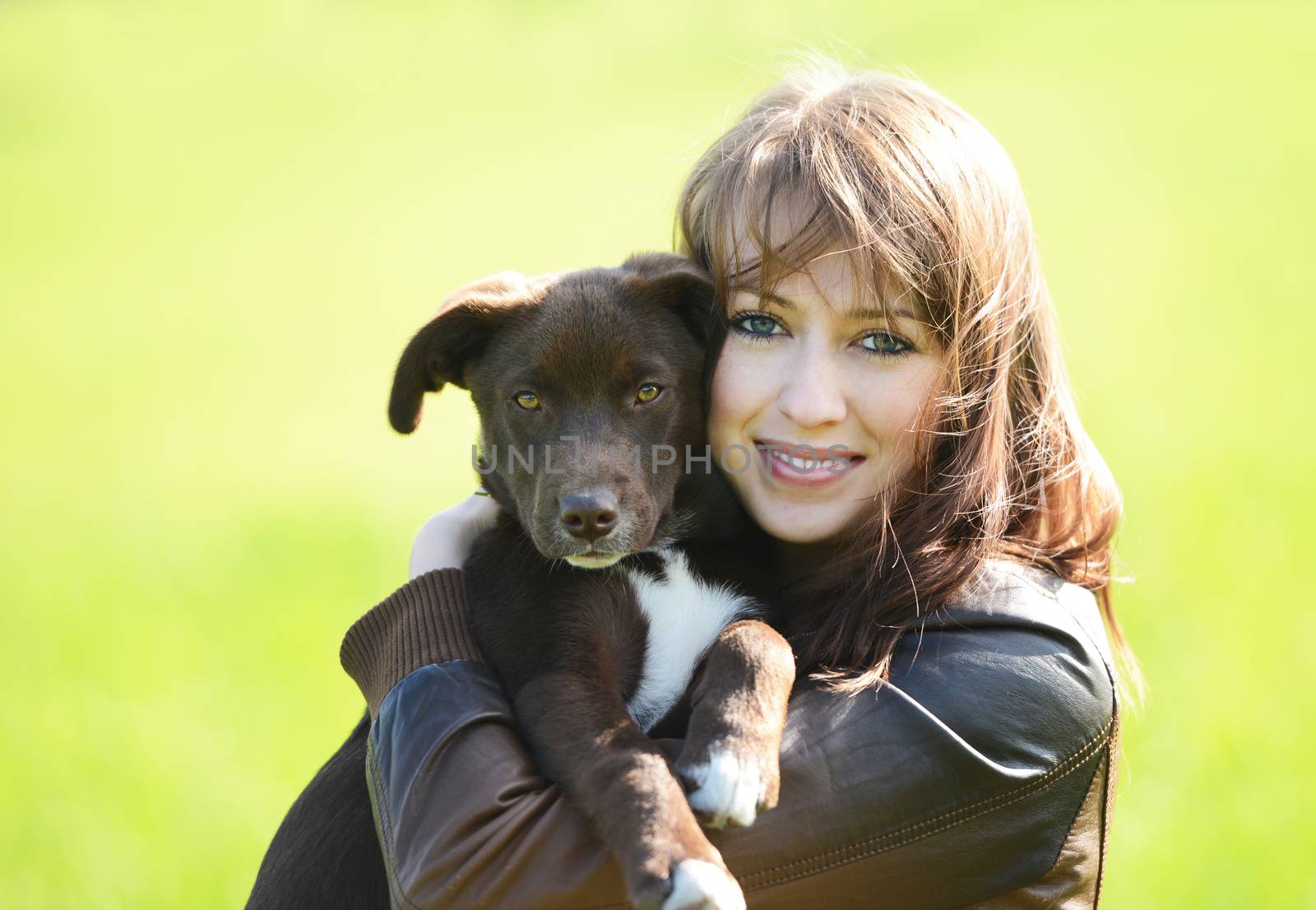 Beautiful young woman holding small cute dog