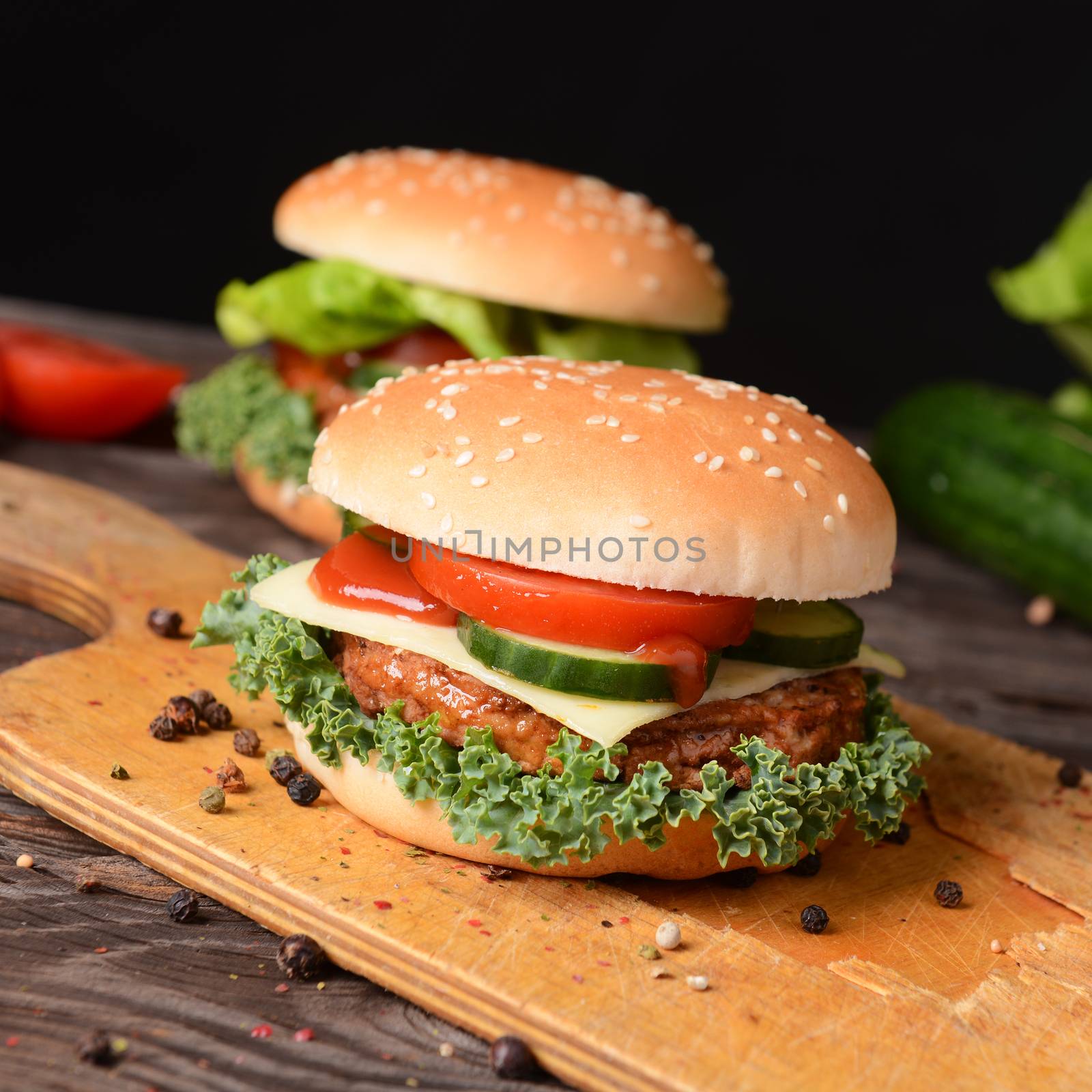 Homemade hamburgers with cheese, tomatoes and cucumbers