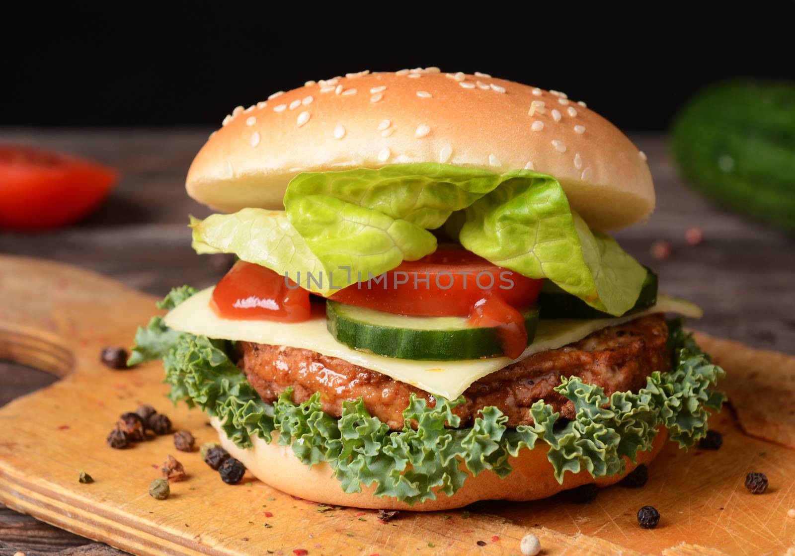 Homemade hamburgers with cheese, tomatoes and cucumbers