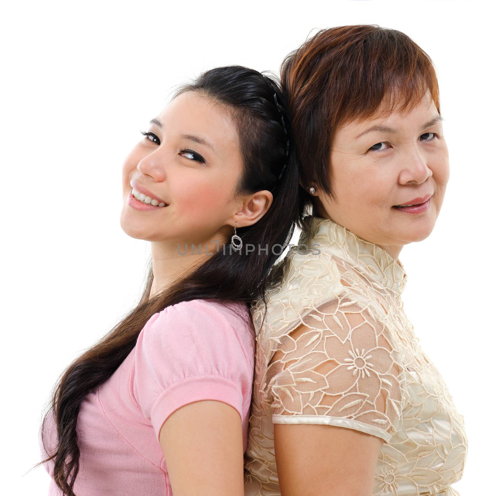 Adult daughter back to back with mother isolated on white background. Mixed race Asian family portrait. 