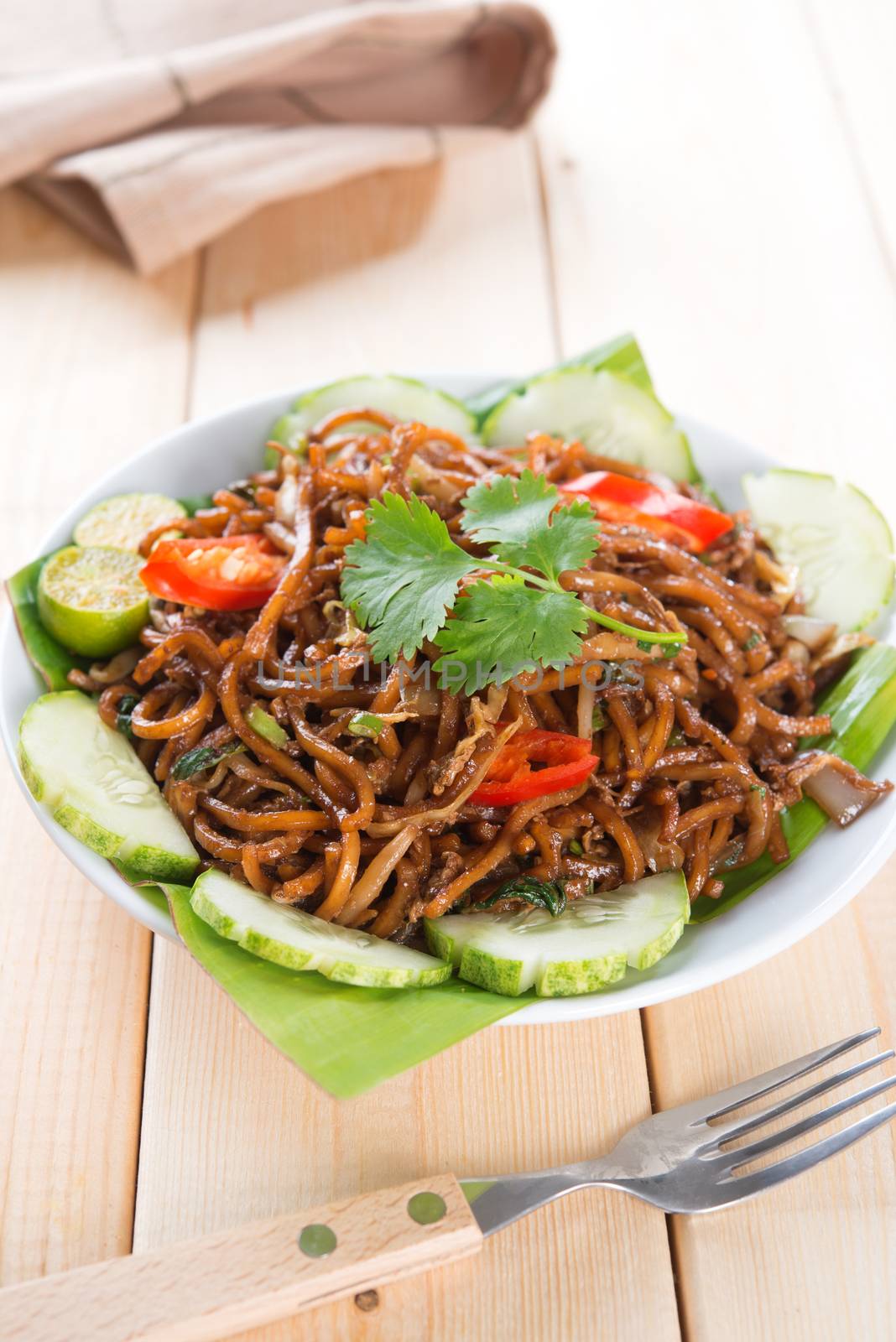 Asian fried noodles, ready to serve on dining table.