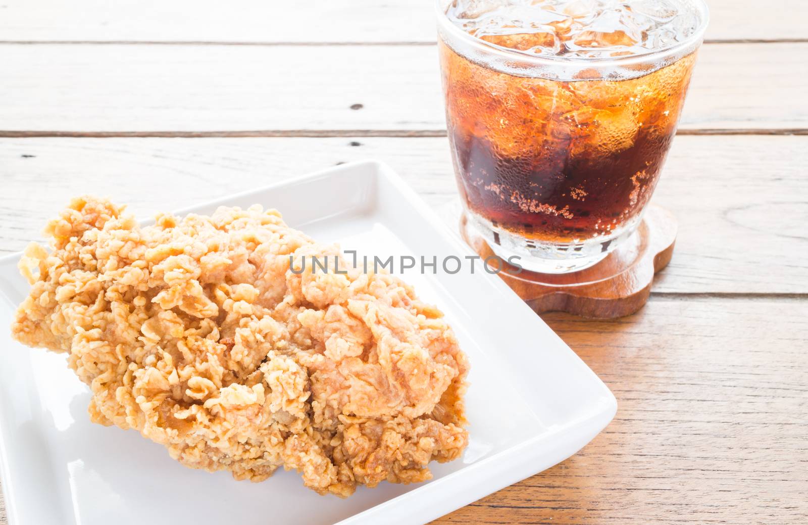 Close up fried chicken with cola drink by punsayaporn