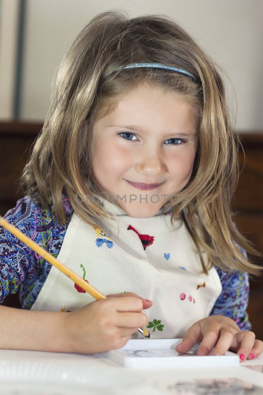 Little girl drawing paint at home