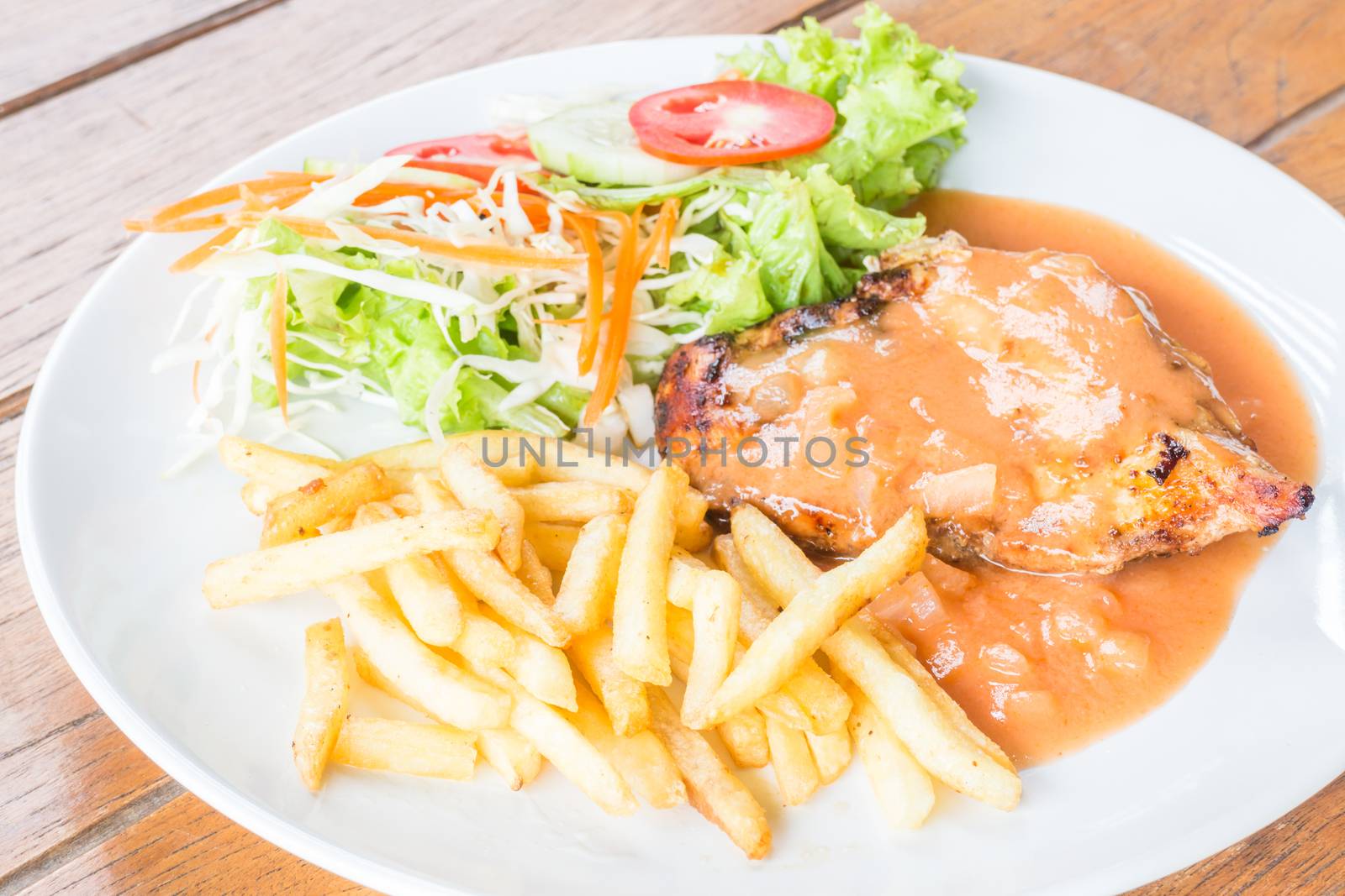 Grilled chicken steak with french fries and vegetables, stock photo