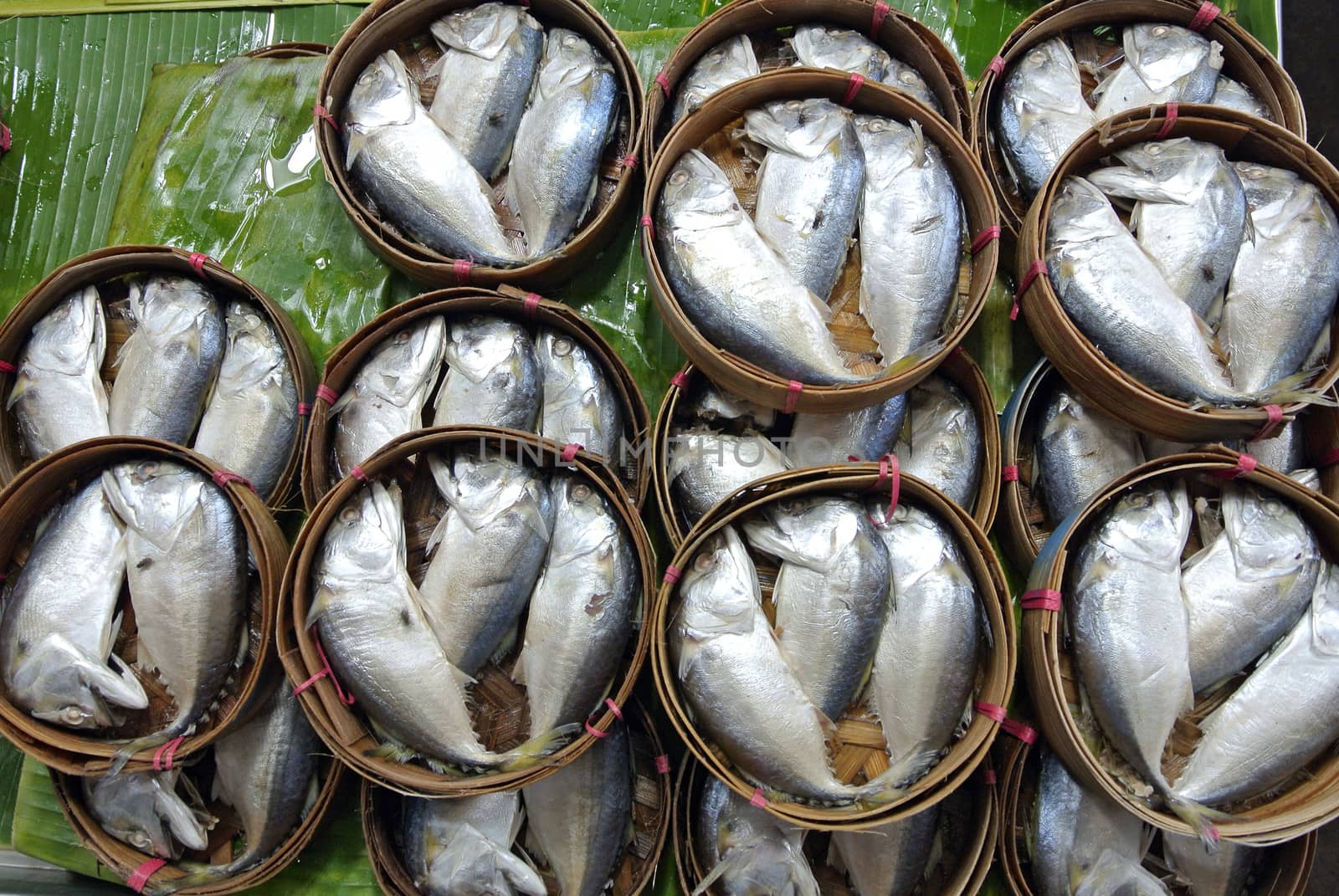 Mackerel fish in bamboo basket at market, Thailand by think4photop