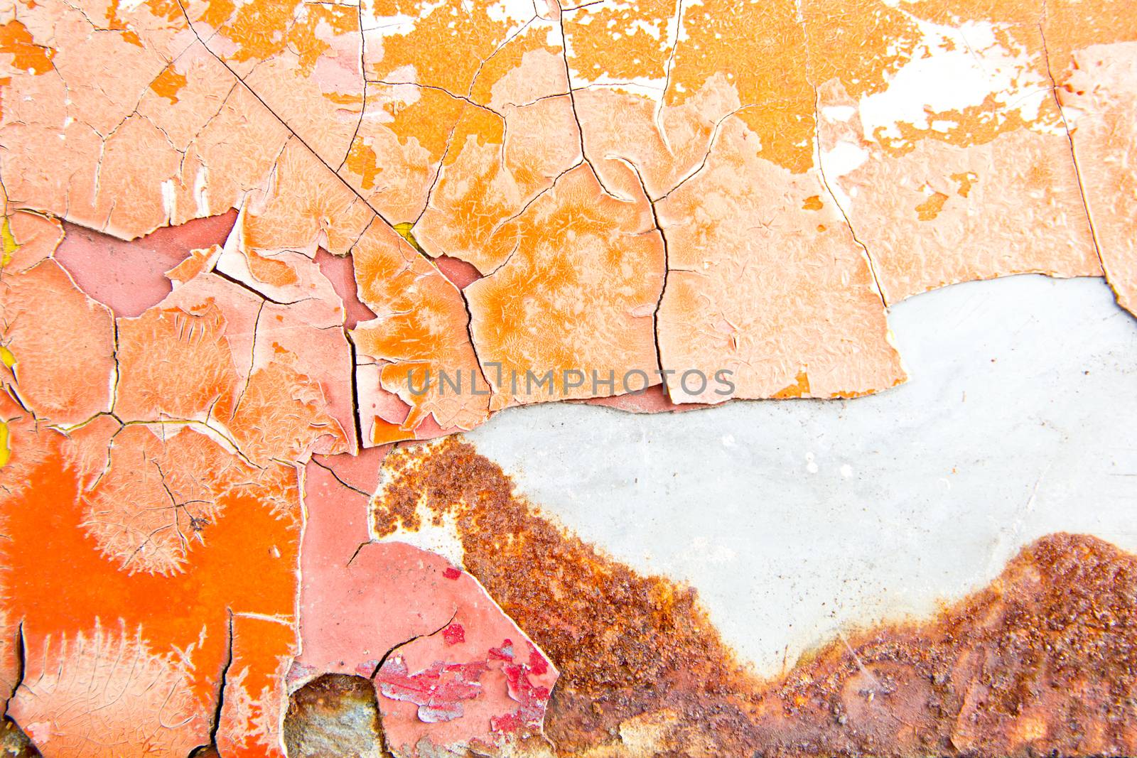 Orange paint flaking on grey metal surface texture