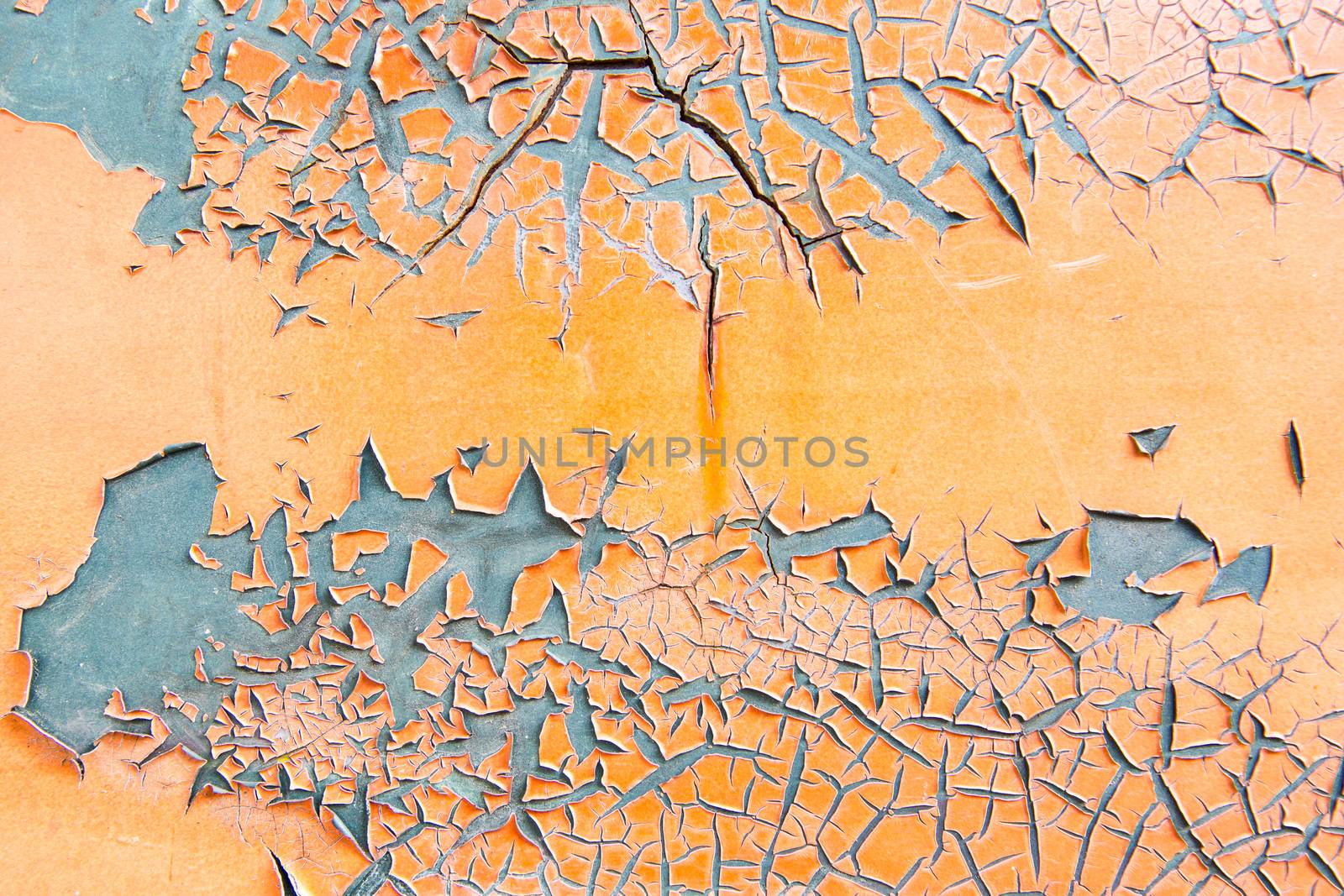 Orange paint flaking on grey metal surface texture