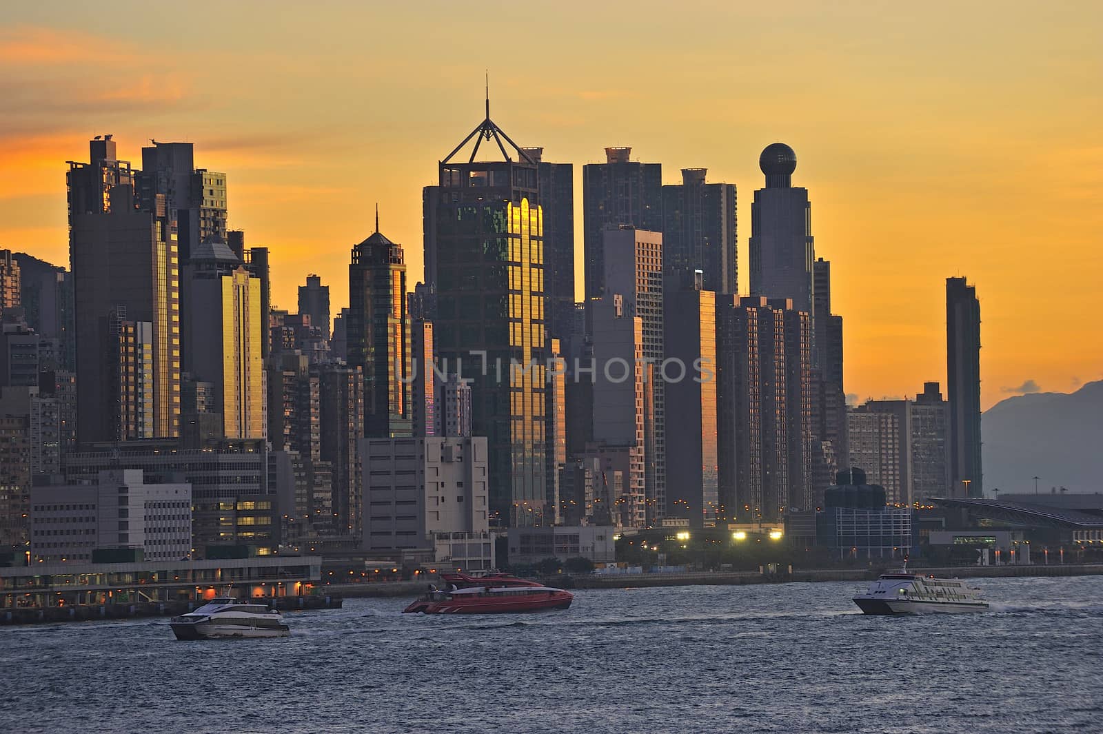 Skyline of Hong Kong at sunset. by think4photop