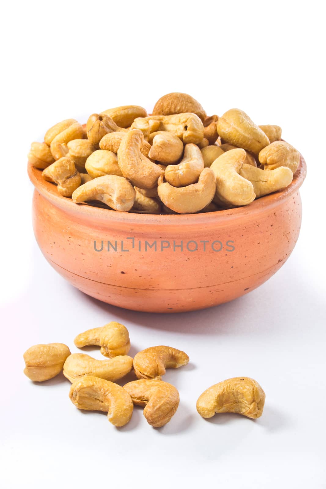 cashews nut in bowl on white background by tisskananat