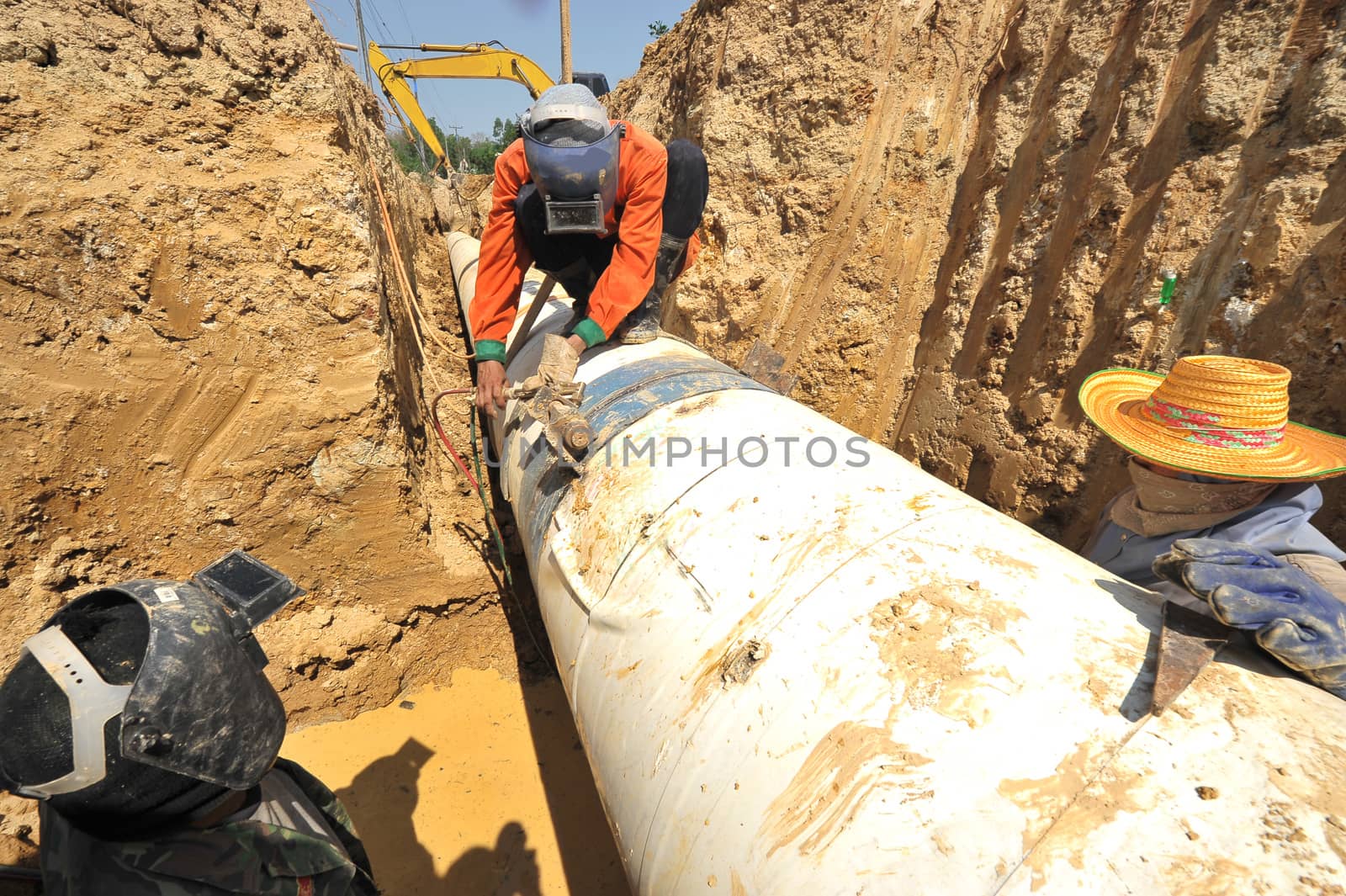 water pipes and worker on duty by think4photop