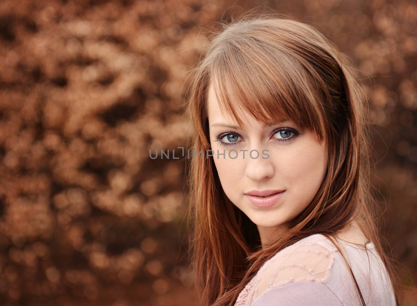 beautiful brunette posing over brown background