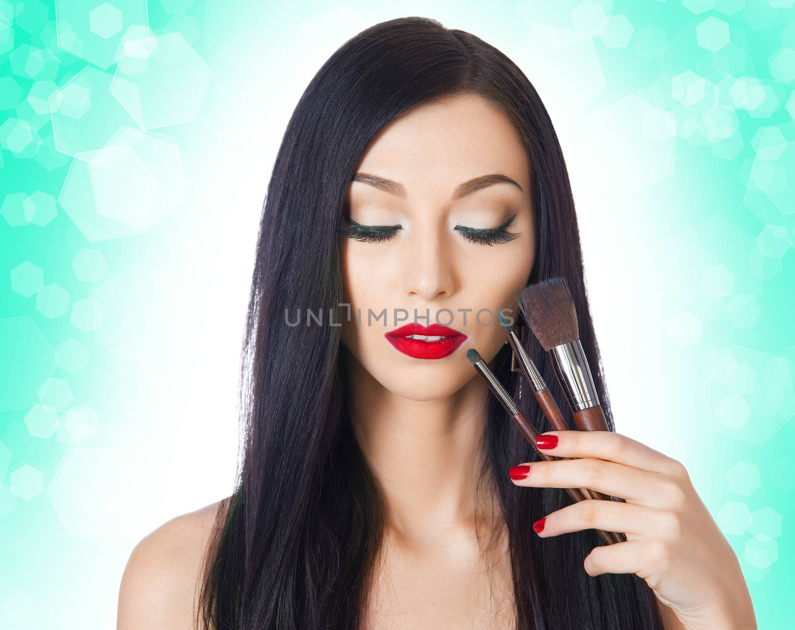 beautiful woman with brushes for makeup on the background bokeh